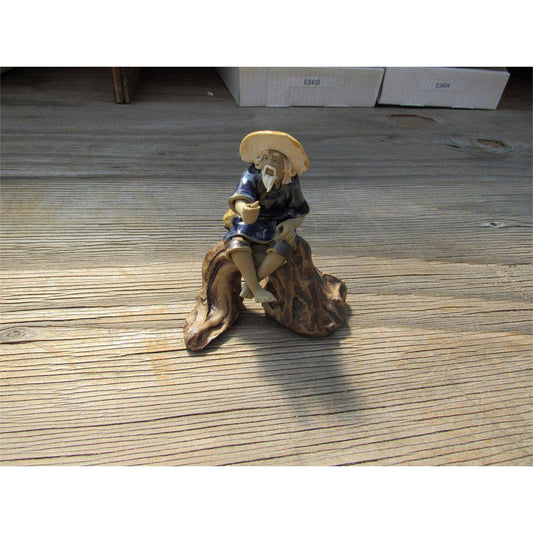 Fisherman Sitting On A Log Ceramic Figurine