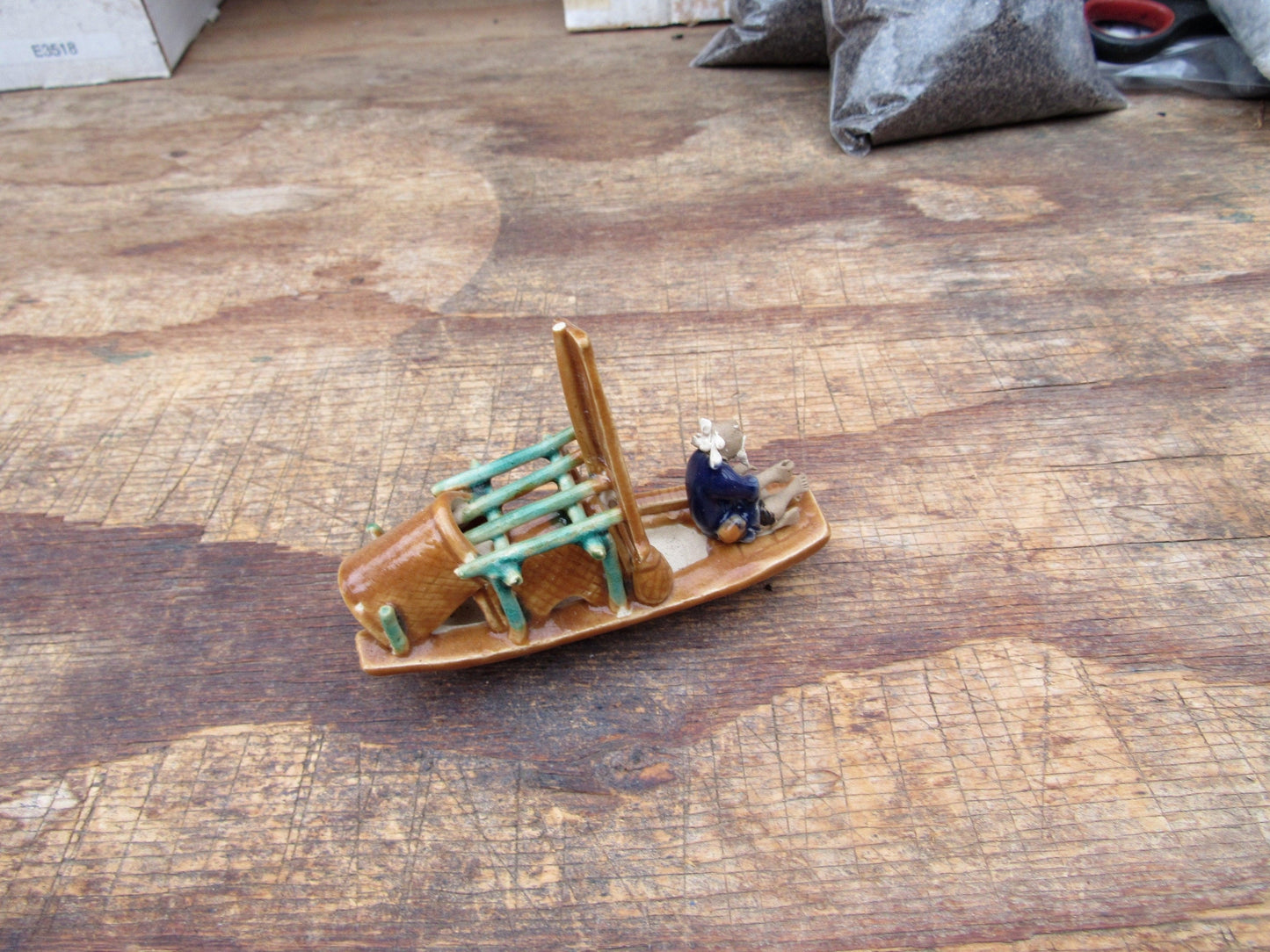 Man on a Large Sampan Boat Figurine